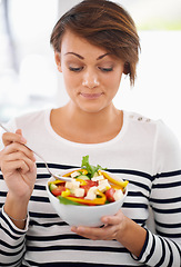 Image showing Young woman, diet and salad or healthy food for detox, breakfast and lunch at home. A happy person with green fruits, vegetables and eating lettuce or vegan meal in bowl for nutrition and wellness