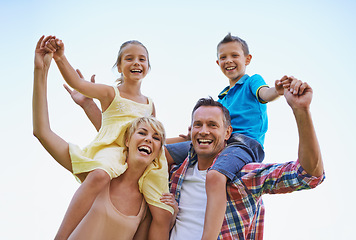 Image showing Portrait, parents and carrying children in park, shoulders and quality time in nature. Love, smile and joyful with happy mother and father on holiday relax, spring or carefree with family on vacation