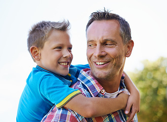 Image showing Piggyback, happiness and dad with kid to play outdoors for bonding, love and support in garden for fathers day. Parent, son and together with care for summer fun in backyard with shoulder game