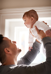 Image showing Father, baby and home with bonding, love and support together with family care and development. Dad, smile and young child in a house with parent playing with newborn and happy about infant growth