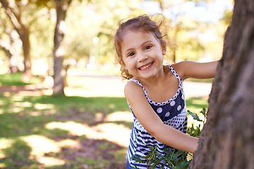 Image showing Young girl, child and portrait in park with games outdoor, playing in nature for childhood and fun with fresh air. Happiness, travel and freedom with youth, public garden or playground with smile