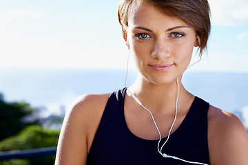 Image showing Outdoor, portrait or woman ready for fitness workout, exercise or healthy wellness in nature park. Sky, listening or face of female sports person on training break with confidence, music or earphones