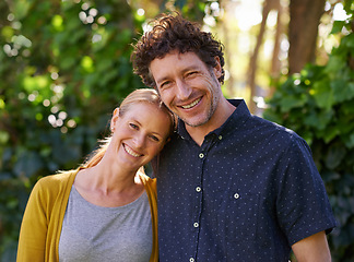 Image showing Love, portrait and happy couple hug in a park for fun, bonding or vacation together in nature. Travel, face and people embrace in a forest with care, trust and support, fun or fresh air in Australia