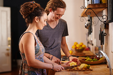 Image showing Home, happy couple and cutting orange in kitchen for healthy diet, nutrition or wellness. Man, woman and chopping board with fruit at table for meal prep or food for organic breakfast in rasta house