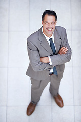 Image showing Happy, portrait and high angle of man in business or office with professional confidence and pride. Above, entrepreneur and person smile in lobby excited for morning in London at corporate workplace