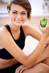 Image showing Portrait, exercise and happy woman with apple in gym for diet, nutrition and wellness with healthy body. Face, fitness and smile of person eating fruit for vitamin c and benefits of organic food