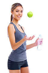 Image showing Happy woman, portrait and fitness with apple or water in natural sustainability or diet on a white studio background. Active female person or athlete with smile, green organic fruit and mineral drink