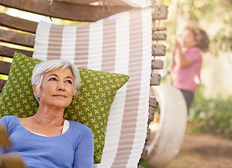 Image showing Senior woman, think and garden with hammock to relax for retirement, break and enjoy. Bokeh, female person and.home with vision in summer or hot weather for outdoor and .satisfied with me time.