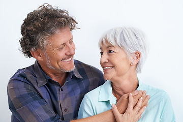 Image showing Old couple, smile with happiness and love in studio, hug and security with comfort for bonding. Marriage partner, retirement and connection with people for trust and loyalty on white background