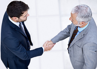 Image showing Top view, business people and shaking hands with CEO for deal, collaboration or b2b partnership agreement for consultant. Above, introduction or handshake with men in office to welcome senior manager