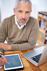 Image showing Portrait, laptop and businessman with tablet in office for statistics research on internet. Serious, computer and mature financial planner work on budget project with digital technology in workplace.