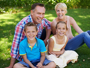 Image showing Garden, grass and relax in portrait of happy family at home with care and love from parents for children. Mother, father and kids smile in backyard on holiday, vacation or together in summer on lawn