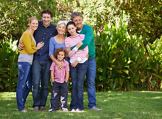 Image showing Family, portrait and hug in outdoor nature, love and bonding together or happy in backyard. Generations, smile and peace or embrace for support in garden or park, vacation and holiday in France