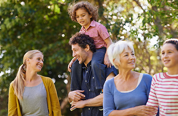 Image showing Family, grandparent and fun in nature, happy and bonding children smile in park and walking. Parents, kid on shoulder and holding while talking, generations together and summer outside with trees