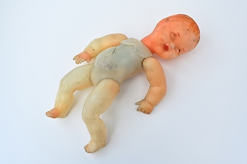 Image showing old broken doll on a white