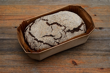 Image showing loaf of fresh rye bread in a wooden box 