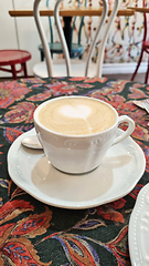 Image showing A cup of coffee on white saucer