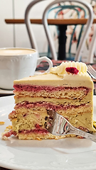 Image showing A piece of cake on a plate with a fork