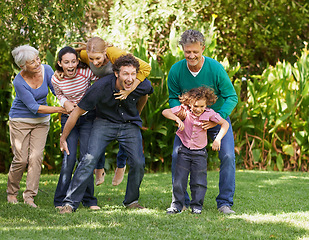 Image showing Family, freedom and playing in outdoor nature, love and bonding together or happy in backyard. Generations, smile and laugh or game for humor in garden or park, vacation and summer holiday in France
