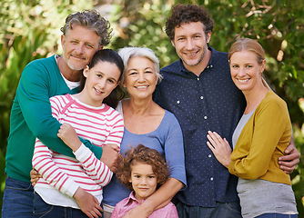 Image showing Family, portrait and hug in outdoor garden, love and bonding together or happy in backyard. Generations, smile and peace or embrace for support in nature or kids, vacation and holiday in France