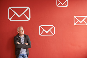 Image showing Email symbol, thinking and senior man with arms crossed, ideas and employee on a red studio background. Mature person, model and guy with planning and icon for communication, decision and envelope