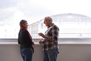 Image showing Window, mature couple and talking for communication, conversation and discussion of retirement holiday. Smile, elderly people and marriage for bonding, commitment and planning for romantic vacation