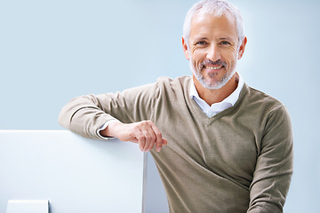 Image showing Mature, businessman and portrait at computer for as boss for tech startup, entrepreneurship or small business. Male person, face and company development or employee, employment or blue background