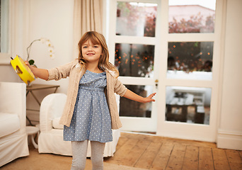 Image showing Little, girl and dance with portrait in living room for fun, entertainment and game with musical instrument. Kid, home and tambourine for sound or music to move, freedom and childhood with happiness.