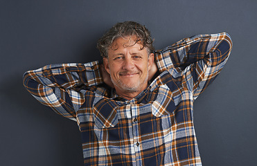 Image showing Mature, man and relax in portrait at studio on dark background with fashion or casual style. Confident, person and smile on face with pride or happy guy on mockup space with plaid pattern on shirt