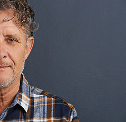 Image showing Half, face and mature man in studio on dark background with model or senior mockup. Confident, person and dermatology portrait with pride or guy relax in space with plaid pattern in fashion