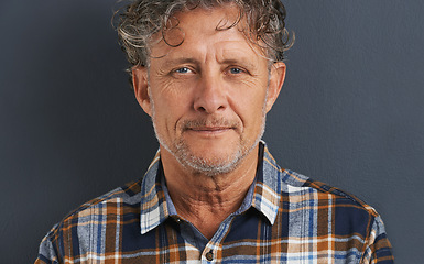 Image showing Mature, man and portrait in studio with fashion on dark background with model or casual style. Confident, person and calm face with pride or guy relax on mockup space with plaid pattern on shirt