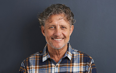 Image showing Mature, man and happy portrait in studio on dark background with fashion or casual style. Confident, person and smile on face with pride or guy relax on mockup space with plaid pattern on shirt