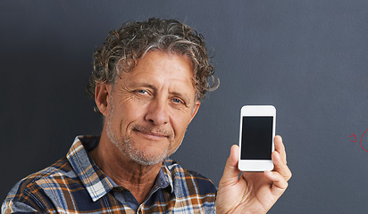 Image showing Mature, man and portrait with cellphone screen in studio for texting communication, grey background or website. Male person, face and smartphone for online internet or browse, display or mockup space