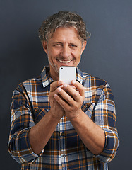 Image showing Mature, man and capture photo with phone in studio and learning about photography on dark background. Smartphone, recording or filming a video for post online to social media for memory or picture