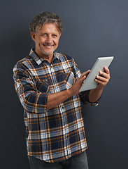Image showing Reading, tablet and portrait of mature man in studio and learning about technology on dark background. Information, tech and mockup with post online to social media or person search internet for news