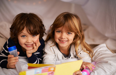 Image showing Book, blanket fort and portrait of children reading for knowledge, learning and education with flashlight. Bonding, relaxing and happy young kids enjoying story or novel together in tent at home.
