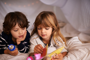 Image showing Reading, blanket fort and children with book for knowledge, learning and education with flashlight. Bonding, relaxing and young kids enjoying story or novel together in tent for sleepover at home.
