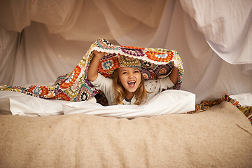 Image showing Happy, blanket fort and portrait of child relaxing and playing hide and seek with quilt at home. Excited, smile and face of girl kid with positive, good and playful expression in bedroom at house.