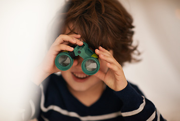 Image showing Boy, child and binocular with toys and playing, youth for fun and innocent with search or surveillance. Investigate, looking or curiosity with discovery on adventure, playful with games and activity