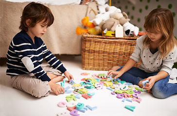 Image showing Children, friends and letter toys for learning, development and games in playroom at home. Young, boy and girl for education and growth in childhood with alphabet, language and kids playing for fun