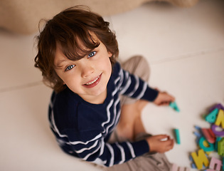 Image showing Boy, child and smile with letter toys to learn, development and games in playroom at home. Portrait, education and growth in childhood with alphabet, language and kid playing for fun with top view