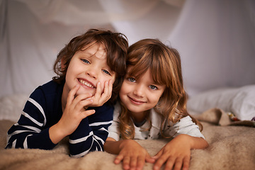 Image showing Happy, blanket fort and portrait of kids relaxing, bonding and playing together at home. Smile, cute and young girl and boy children siblings laying in tent for fun sleepover in bedroom at house.