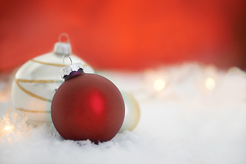Image showing Christmas, decor and interior with bauble in festive season, holiday or weekend on snow or studio background. Closeup of empty decoration with red ball, ornament or December equipment on mockup space