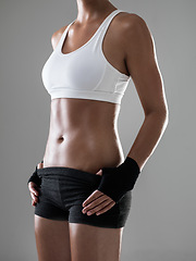 Image showing Woman, six pack with body and kickboxing for fitness, strong with muscle and sweat from workout on grey background. Boxing, self defense training and athlete for sports, exercise and power in studio