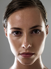 Image showing Woman, serious face and confidence for fitness, strong and determined with sweat from workout on grey background. Headshot, portrait and athlete for sports, exercise with pride and power in studio