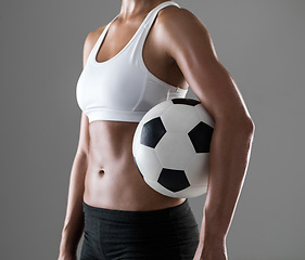 Image showing Woman, closeup and soccer player with ball for match, game or fitness on a gray studio background. Body of female person or athlete with football for sports exercise, workout or training on mockup