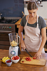 Image showing Woman, fruit and blender for healthy smoothie in kitchen for weight loss nutrition, chopping board or ingredients. Female person, knife and preparation for vegan snack in apartment, organic or detox