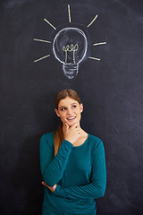 Image showing Thinking, creative and woman with light bulb on chalkboard for inspiration, brainstorming and problem solving. Idea, question and person on background with icon for solution, thoughtful and planning