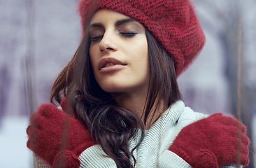 Image showing Fashion, beauty and young woman with winter clothes on cold weather vacation or holiday. Serious, makeup and face of female person with gloves, jersey and beanie for trendy style for weekend trip.