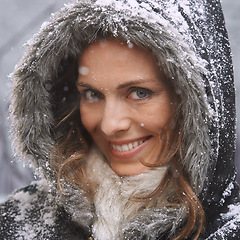 Image showing Woman, smile in portrait and snow in winter season with fur coat for fashion, good mood and outdoor for travel. Peace, calm and cold with comfort in jacket for weather, ice or frozen with nature